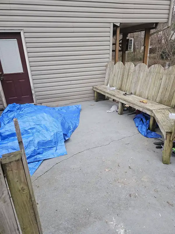 The same patio with the pile removed and the blue tarp still present