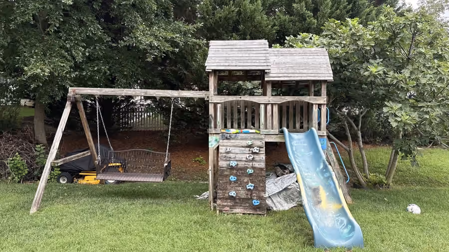 An old wooden playset in a fenced Richmond back yard, with our text reply: firm price sent, Thursday 2pm