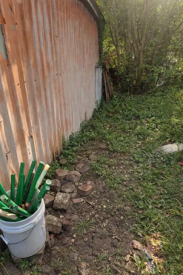 The same shed wall with the debris pile removed