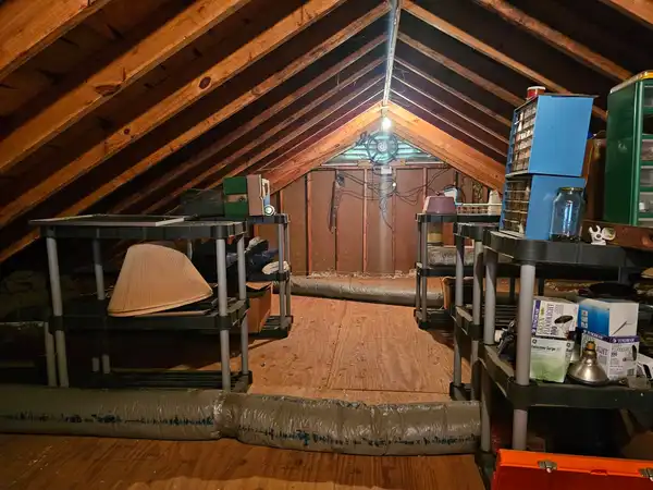 The same attic with a cleared center aisle and items retained on shelving